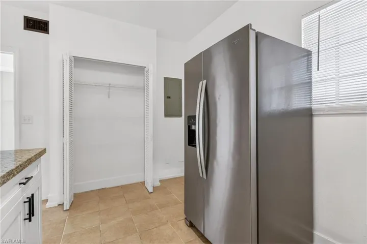 Kitchen featuring stainless steel fridge and electric panel