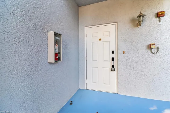 Property entrance featuring stucco siding