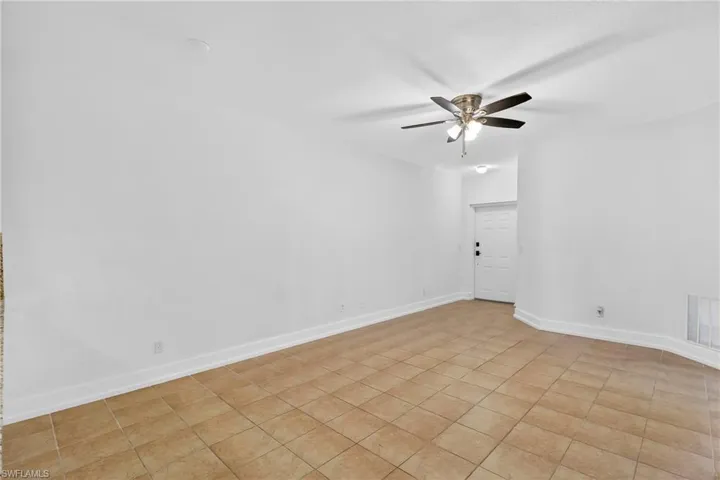 Unfurnished room with ceiling fan and light tile patterned floors