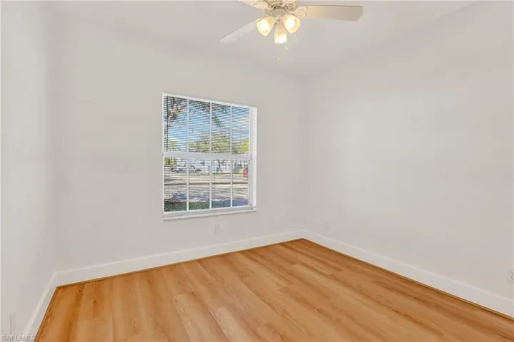 Unfurnished room with light wood-type flooring and a ceiling fan
