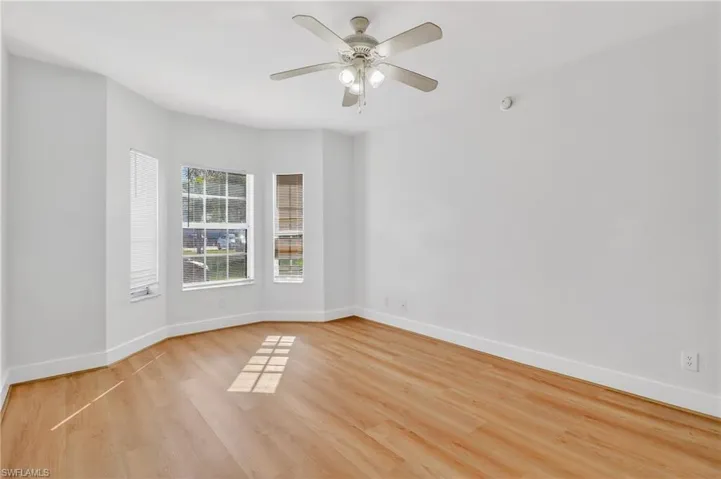 Empty room featuring light wood-style flooring and a ceiling fan