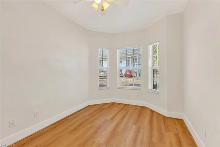 Empty room featuring light wood-style flooring and ceiling fan