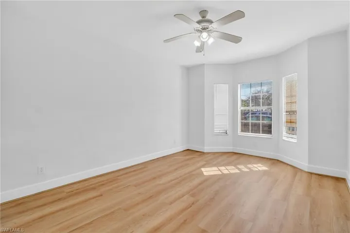 Unfurnished room featuring ceiling fan and light wood-style floors