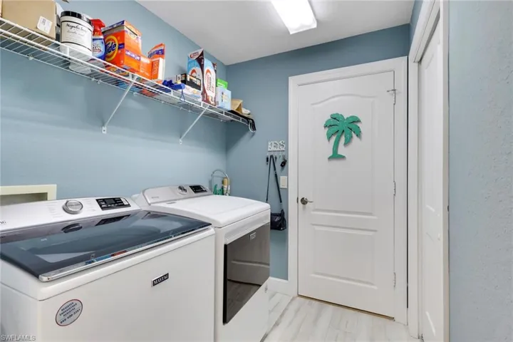 Laundry room with washing machine and clothes dryer