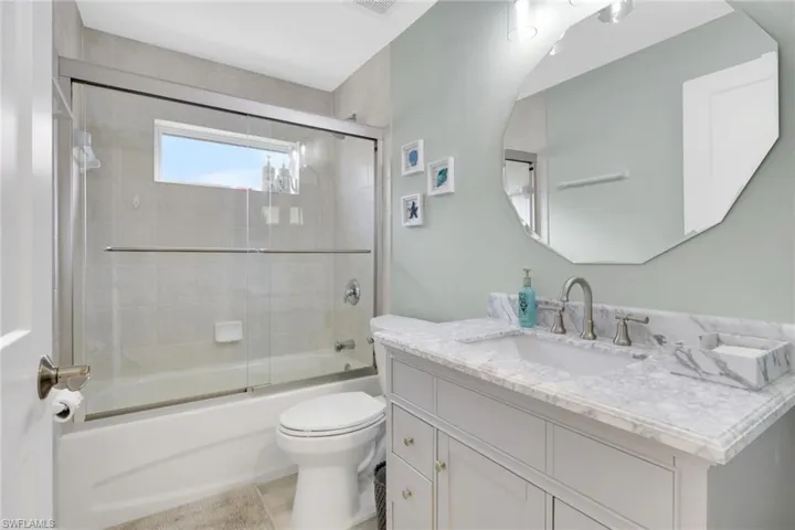 Bathroom with vanity and shower / bath combination with glass door