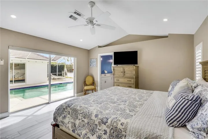 Bedroom featuring a sunroom, access to outside, wood finished floors, ceiling fan, and recessed lighting