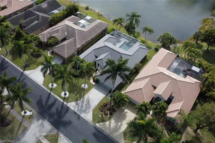 Aerial perspective of suburban area featuring a nearby body of water