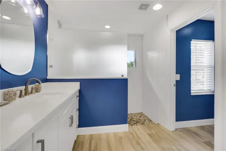 Bathroom with vanity, light wood-type flooring, and recessed lighting