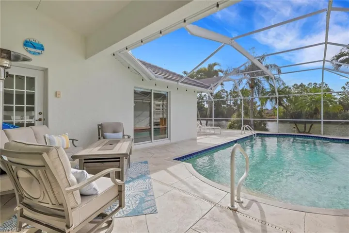 Swimming pool with a patio area, a lanai, and a sunroom