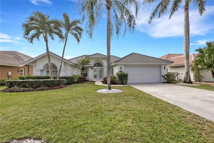 Ranch-style home with french doors, stucco siding, a front yard, and driveway