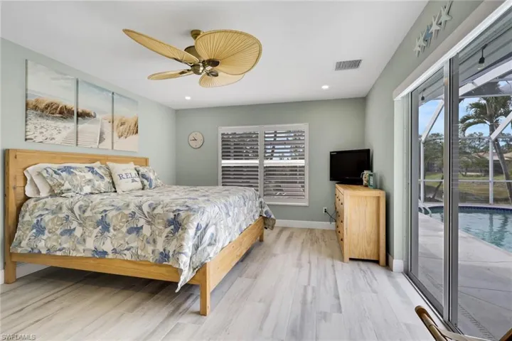 Bedroom with access to outside, wood finished floors, a ceiling fan, and recessed lighting
