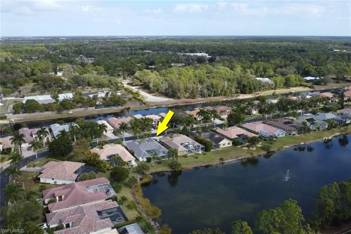 Aerial view of property's location featuring nearby suburban area and a nearby body of water