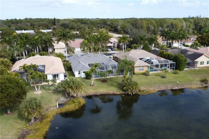 Aerial view of residential area featuring a nearby body of water