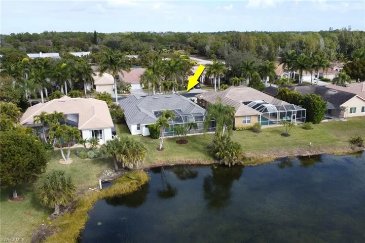 Aerial perspective of suburban area featuring a nearby body of water