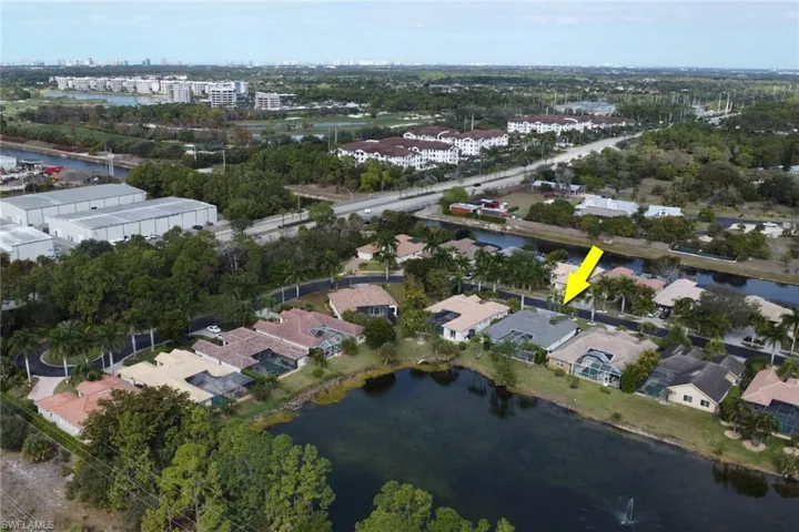 Aerial view of property and surrounding area featuring a nearby body of water