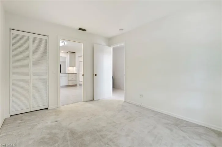 3rd Bedroom or Office: view of door to foyer and kitchen with closet for extra storage