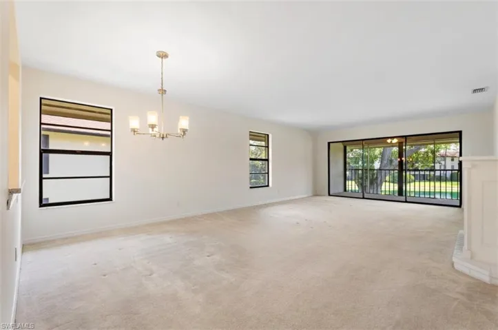 View of the dinning area and living room area show casing the beautiful view of the lanai, this end unit has extra light with windows on the side.