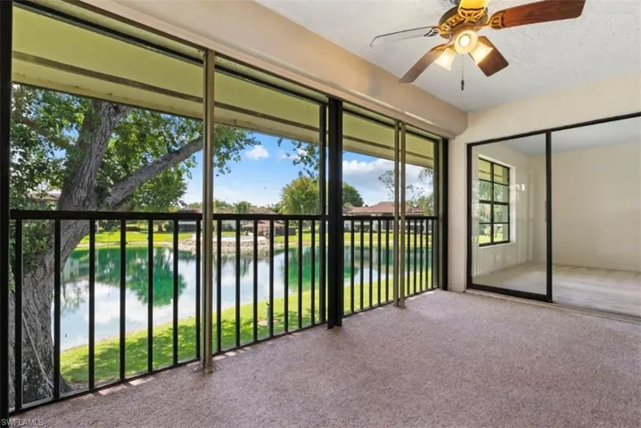 Enjoy this enclosed balcony looking toward the lake and pool.