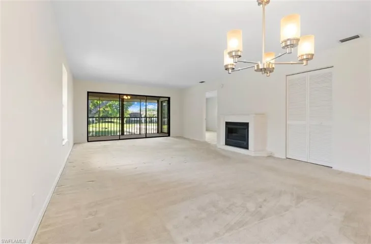 View of the dining and living room with electric fireplace.