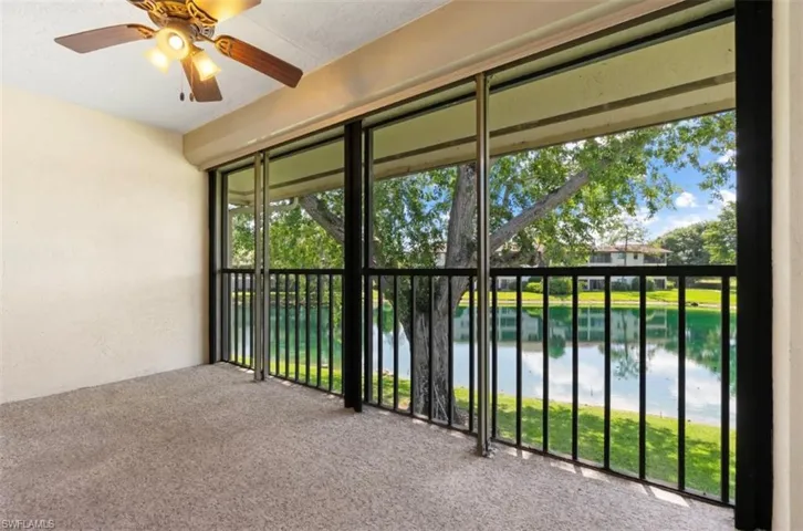 Enjoy this enclosed balcony looking toward the lake and pool.