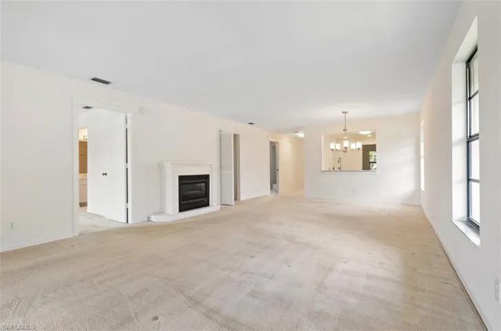 View from the living room to the kitchen, extra storage closet in the dining area could be a pantry