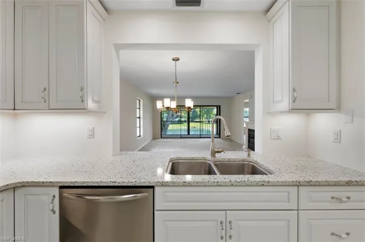Kitchen open to dining room and view of the lanai and lake