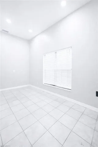 Unfurnished room with recessed lighting and light tile patterned floors