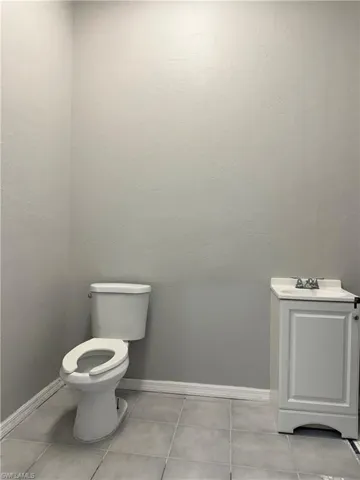 Half bath featuring vanity and light tile patterned floors