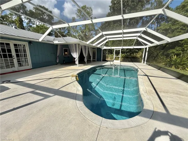 Three sets of french doors lead to pool area.