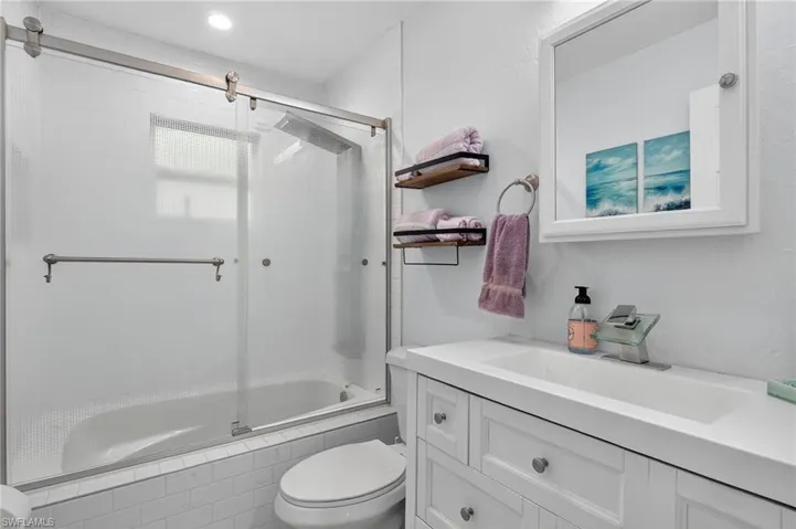 Bathroom featuring tiled shower / bath combo and vanity