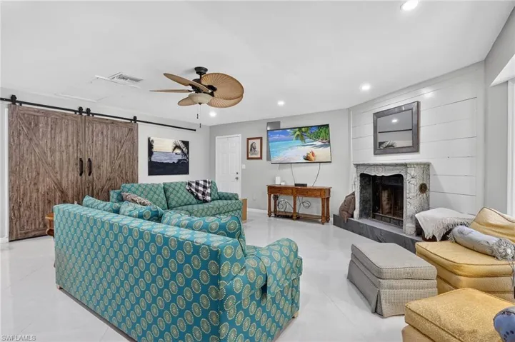 Living/laundry area has sliding barn doors with brand new washer & dryer and side door that opens to outdoor fenced yard.