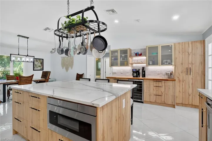 Seller added spacious pantry and expanded island storage in the kichen remodel.