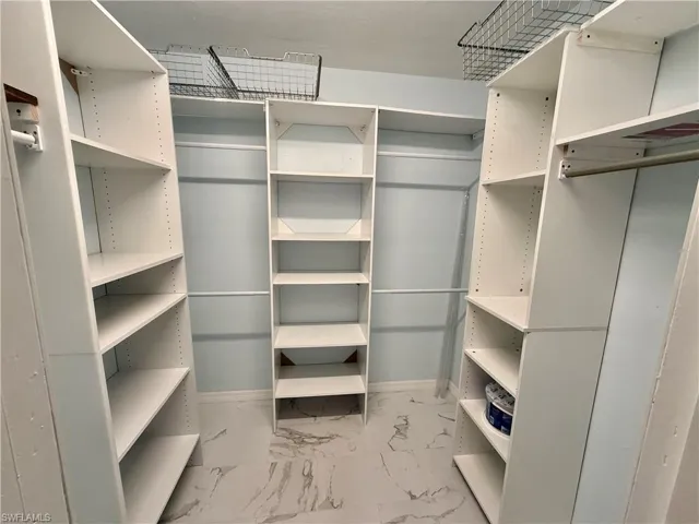 2nd master closet is a walk-in with built in shelving.