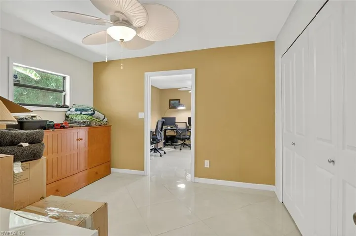 3rd bedroom adjoins to den/4th room with ceiling fan and large closet with built-in shelving.