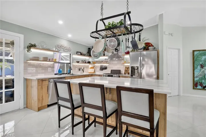 Pan fixture and barstools are included in the kitchen.