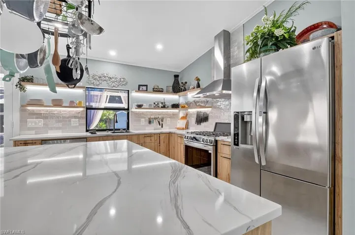 Beautiful gleaming quartz countertops and gorgeous backsplash make this kitchen a show stopper!