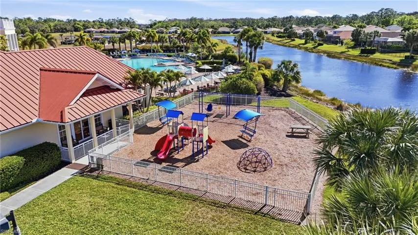 Aerial perspective of suburban area featuring a large body of water