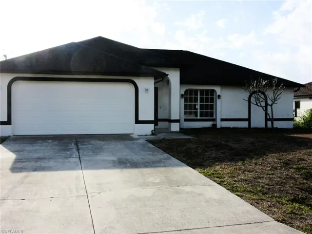 Ranch-style home featuring concrete driveway, stucco siding, and an attached garage