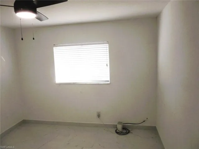 Unfurnished room with baseboards and light marble finish flooring