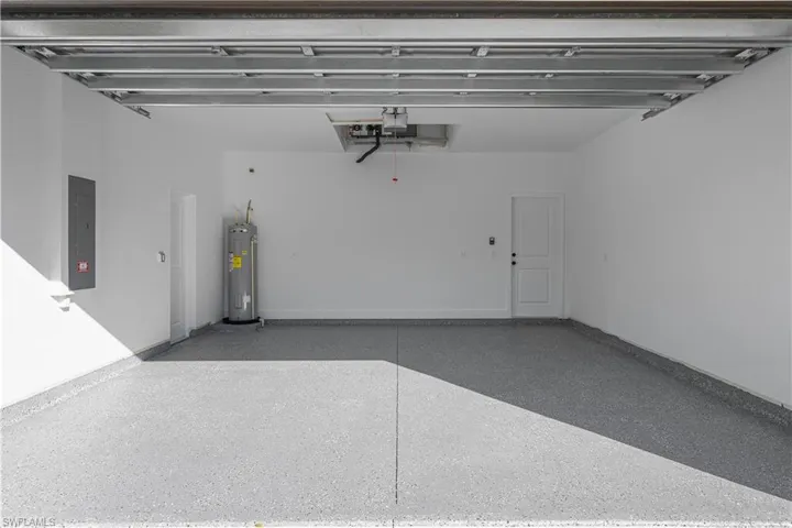 Garage with water heater and electric panel
