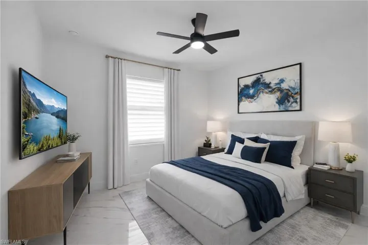 Bedroom with a ceiling fan and baseboards