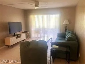 Living area featuring a ceiling fan and healthy amount of natural light
