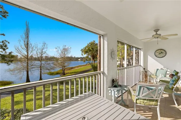 Wooden terrace with a ceiling fan and a water view