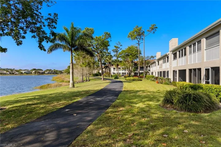View of home's community featuring a lawn and a water view