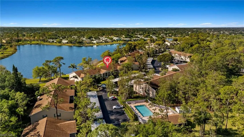 Birds eye view of property featuring a residential view, a water view, and a view of trees