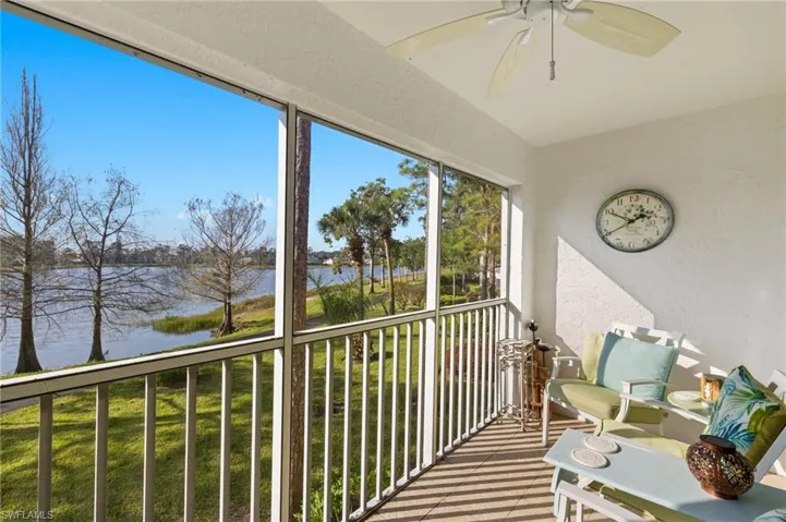 Balcony with a water view and ceiling fan