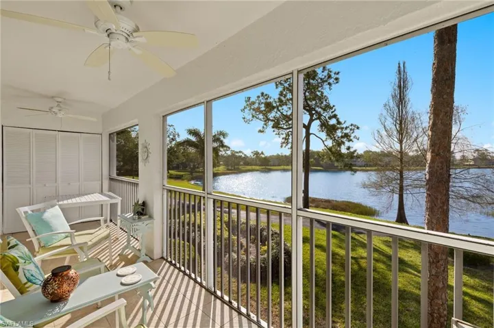Unfurnished sunroom with a water view and ceiling fan