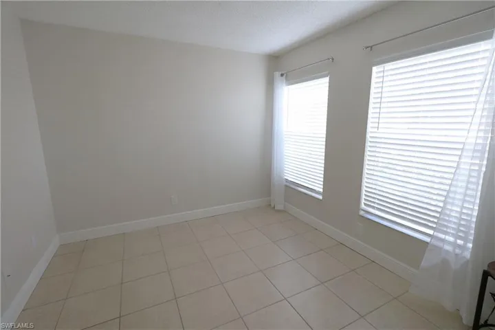 Spare room with light tile patterned flooring and a textured ceiling