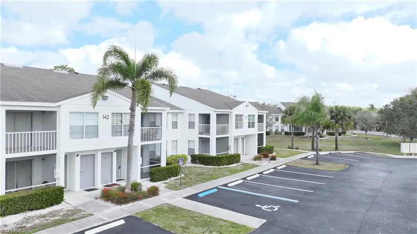 View of property featuring uncovered parking