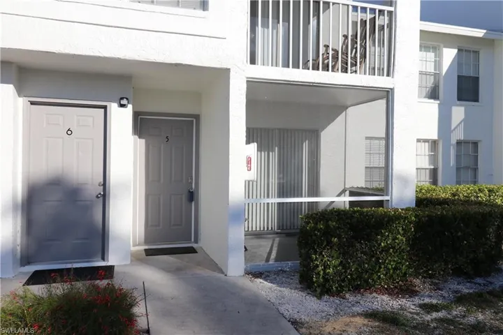 Property entrance with stucco siding and covered porch